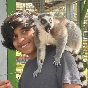 Jonas with a lemur on his shoulder